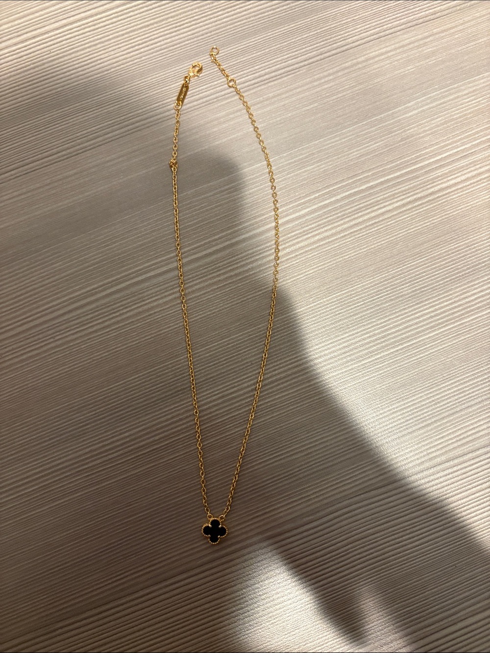 Gold Necklace with Black Clover Pendant